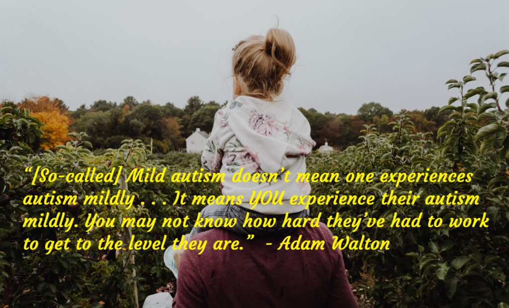 Girl sitting on fathers shoulder, Autism Awareness Day.