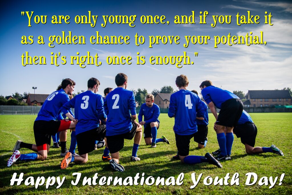 Football players discussing strategy on ground, International youth day.